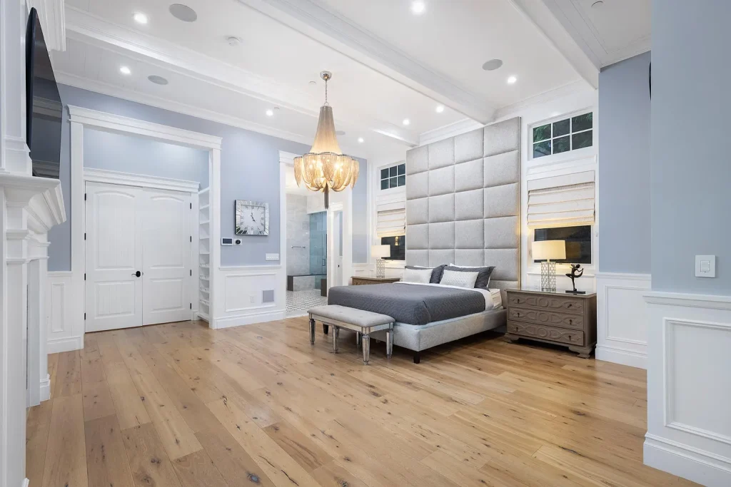 An elegant private bedroom features a comfortable bed and calming neutral decor, with natural light streaming through the windows, creating a serene atmosphere ideal for relaxation during a recovery journey. This tranquil space could serve as a comforting environment for individuals attending treatment programs, such as 90 day rehab, focusing on substance use disorder and addiction recovery.