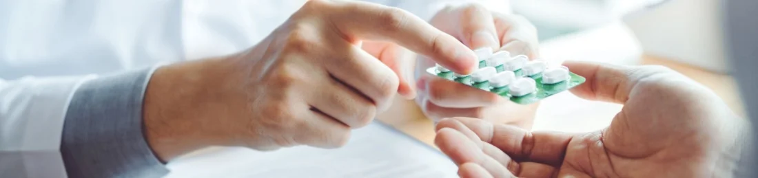 Doctor-hands-patient-a-packet-of-medication