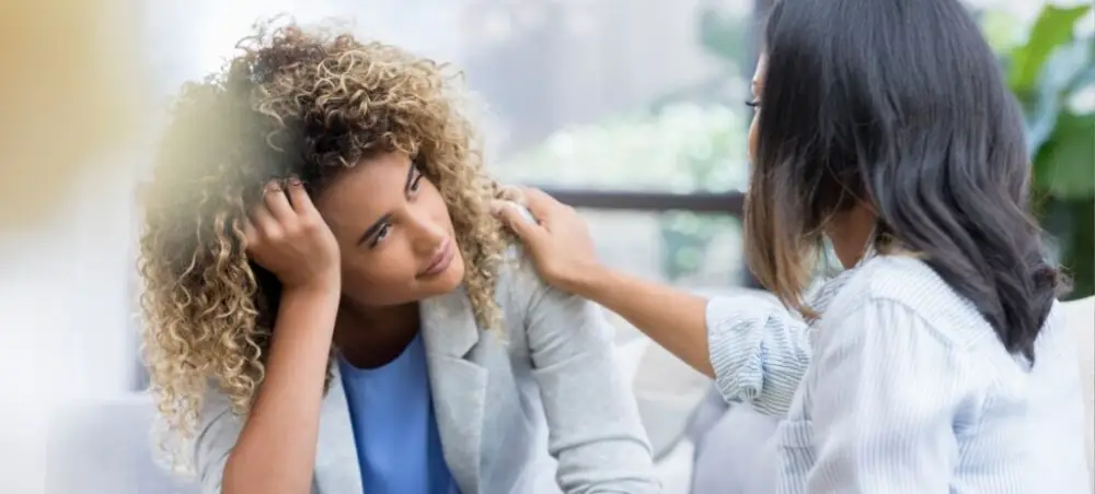 A healthcare professional providing emotional support to a patient during addiction treatment with the Vivitrol shot